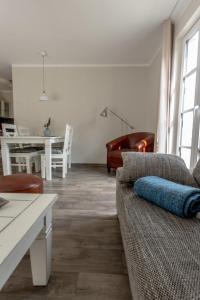 a living room with a couch and a table at Villa-Borwin-Apartment-2 in Kühlungsborn