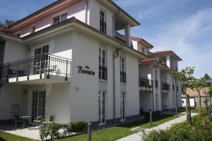 a white building with a sign on it at Villa-Borwin-Apartment-9 in Kühlungsborn +9 photos