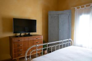 a bedroom with a bed and a television on a dresser at * * * * * Splendida casa di campagna in Castenaso