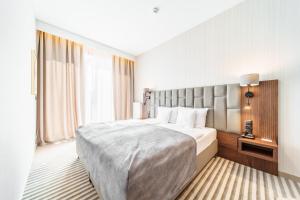 a hotel room with a bed and a large window at Elements Hotel&Spa in Świeradów-Zdrój