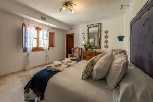 a bedroom with a large bed with pillows on it at La Casona Verde in Almodóvar del Río +153 photos