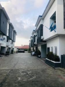 an empty parking lot in front of some buildings at Beautiful 4-Bedroom House in Ogombo