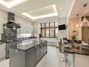 a kitchen with a large island with a counter top at Buntingfield Farmhouse in Ashover