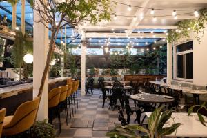 a restaurant with tables and chairs and plants at Theodor Brown Rothschild Tel-Aviv, a member of Brown Hotels in Tel Aviv