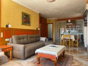 a living room with a couch and a table at Villa Symbola in Oludeniz