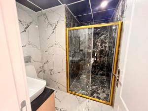 a shower with a glass door in a bathroom at Lahza Apart Hotel in Trabzon