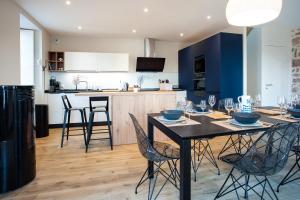 a kitchen and dining room with a table and chairs at Le Grand Banc - Maison typique pour 6 in Erquy