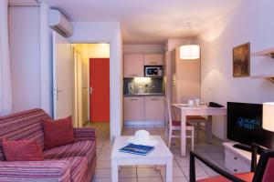 a living room with a couch a table and a kitchen at Wonderful La Villa du Lac - One Bedroom, 4 people in Divonne-les-Bains