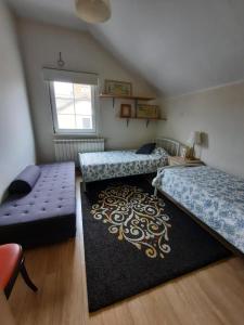 a bedroom with two beds and a rug at Dream apartments in Novi Sad