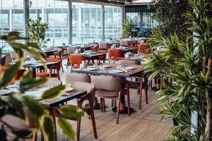 a restaurant with tables and chairs and plants at Destiny Marine Hotel in Istanbul