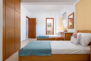a hotel room with two beds and a bathroom at Artoria Apartment 2 First Floor in Haraki