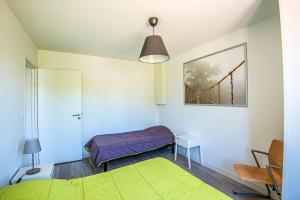 a bedroom with a bed and a table and a picture at Gîte Martin pêcheur au coeur de la nature in Moncoutant +19 photos