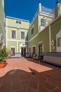 a large building with a patio in front of it at La Casona Verde in Almodóvar del Río