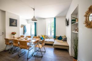 a dining room and living room with a table and chairs at Gîte Libellule au coeur de la nature in Moncoutant