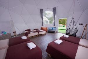 a room with four beds in a tent at Glamz at Genting in Genting Highlands