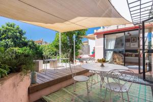 un patio con mesa y sillas en una terraza en Secret Garden House en Lisboa