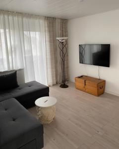 a living room with a couch and a flat screen tv at Seeglück22 in Reichenau