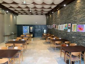 un comedor con mesas y sillas y una pared de ladrillo en Spa Hotel Ciudad de Teruel, en Teruel