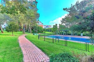 a brick walkway next to a swimming pool at Estate Lifestyle+Inverter+Wi-Fi in Roodepoort