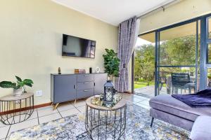 a living room with a couch and a tv at Estate Lifestyle+Inverter+Wi-Fi in Roodepoort