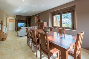 a dining room with a wooden table and chairs at La Casonia in Anero
