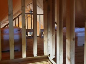 a view of a wooden room with two beds at Safaritent Betuwe Lodge in Kesteren