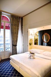 Postel nebo postele na pokoji v ubytování Carlton Lausanne Boutique Hôtel + 37 fotografií