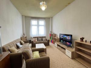a living room with a couch and a tv at Family Apartments Thale in Thale