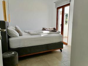 a bed with shoes sitting on it in a room at Villa Bora - Ferienhaus am Meer in Slatine +61 photos