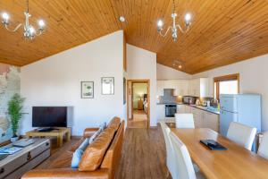 a large living room with a couch and a table at Douglas Fir Lodge with Hot tub in Cupar