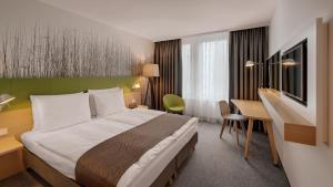 a hotel room with a bed and a desk at Holiday Inn Frankfurt - Alte Oper, an IHG Hotel in Frankfurt