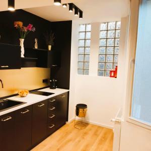 a kitchen with black cabinets and a window at Historical Center by 4EL in Bucharest