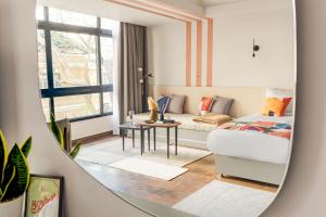 a living room with a bed and a mirror at Brassbell apartments in Giza in Cairo