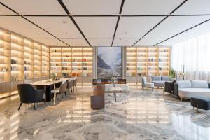 a rendering of a library with couches and a table and chairs at Atour Hotel Suzhou Railway Station North Square Bole Shi in Suzhou