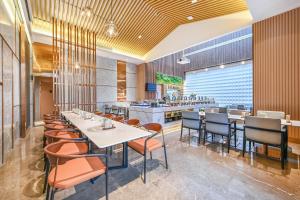 a restaurant with tables and chairs and a bar at Atour Hotel Beijing Joy City Chaoyang Road in Beijing