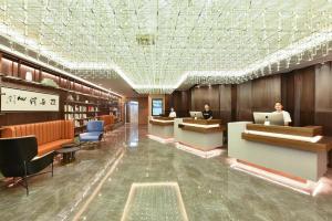 a lobby with people sitting at computers in a library at Atour Hotel Beijing Chaoyangmen in Beijing