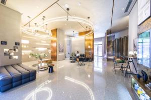 a lobby with a couch and a table and chairs at Atour S Hotel Tianjin Binjiang Road Hanglung Plaza in Tianjin