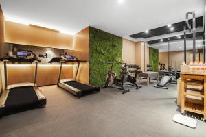 a gym with bikes and exercise equipment in a room at Atour Hotel Chongqing Jiefangbei in Chongqing