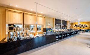 a restaurant with a counter with a lot of dishes at Atour S Hotel Binhe Times Shenzhen in Shenzhen