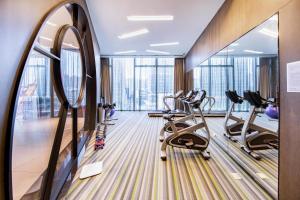 a fitness room with treadmills and ellipticals at Atour S Hotel Binhe Times Shenzhen in Shenzhen