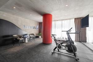 a room with a gym with a treadmill and a red column at Atour Hotel Guangzhou Zhujiang New Town Wuyangtun in Guangzhou