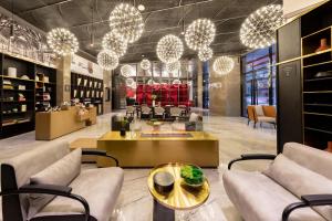 a lobby with couches and tables and chandeliers at Atour Hotel Chengdu High-tech Tianfu 2nd Street in Chengdu