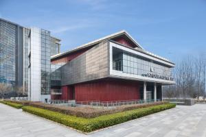 a large building with a red building at Atour Hotel Capital Airport Beijing in Beijing