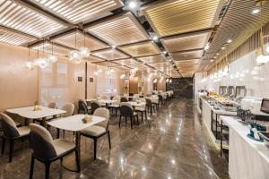 a restaurant with tables and chairs in a room at Atour Hotel Suzhou Guanqian Street in Suzhou