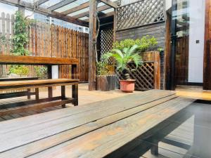 a wooden deck with benches and a potted plant at Atour Hotel Shanghai Lujiazui Minsheng Road Station in Shanghai