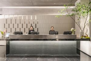 two women sitting at a desk in a lobby at Atour S Hotel Shanghai Lujiazui Expo Center in Shanghai