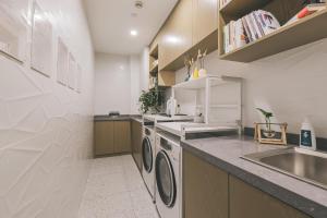 a kitchen with a sink and a washing machine at Atour Light Hotel Shanghai East Nanjing Road 130 in Shanghai