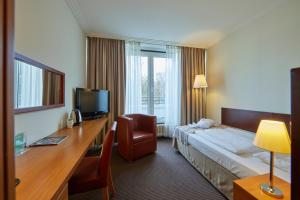 a hotel room with a bed and a desk at Hotel Bredeney in Essen