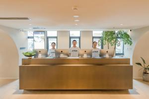 a group of women standing at a counter in an office at Atour S Hotel Beijing Guomao CBD - FunsCenter in Beijing