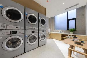 a laundry room with four washer and dryer machines at Atour S Hotel Beijing Zhongguancun Beiwai in Beijing +10 photos